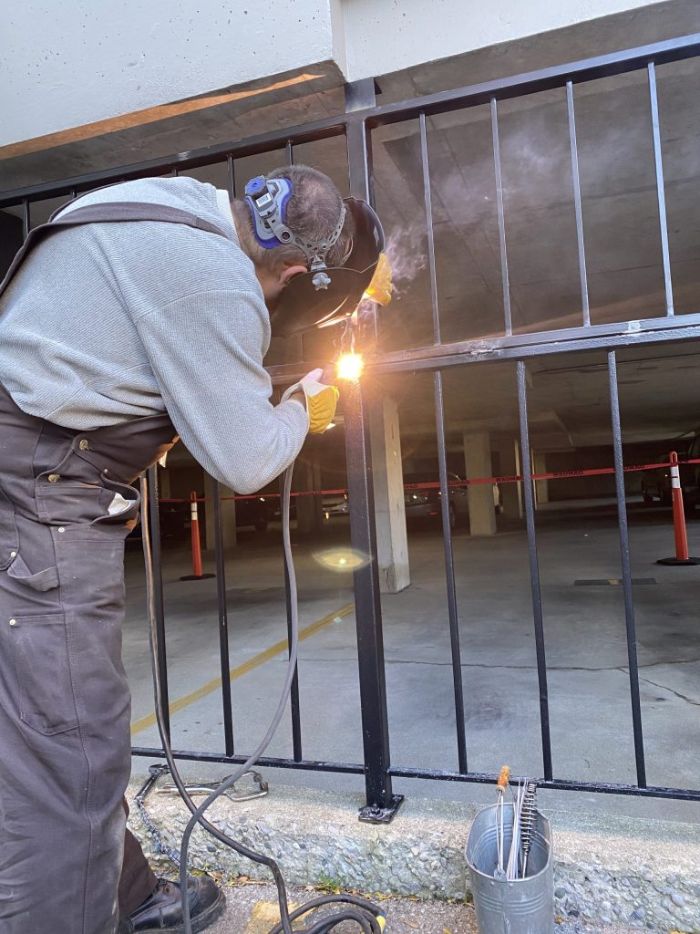 Welding guardrail on top of handrail. JW Portable Welding & Repairs, London, Ontario, 2021