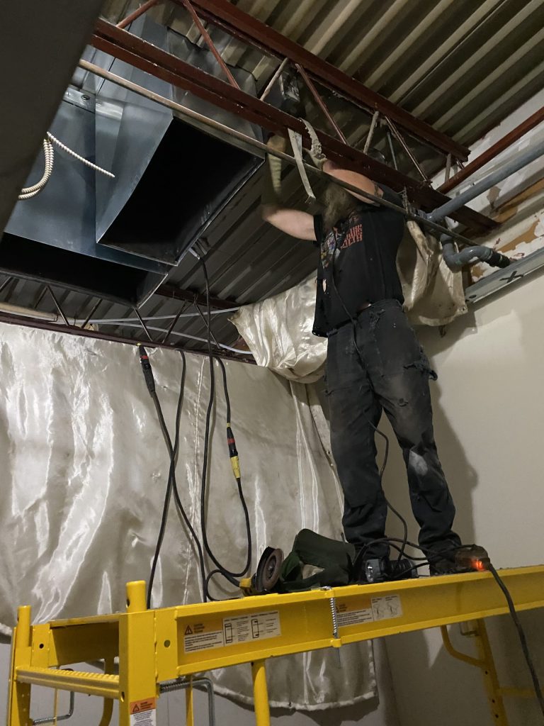 Worker fits reinforcement elements of the scaffold. JW Portable Welding & Repairs 2021
