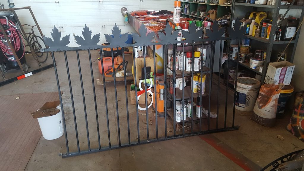Iron fence with large maple leaves with sharp edges in black. JW Portable Welding & Repairs 2020 London Ontario