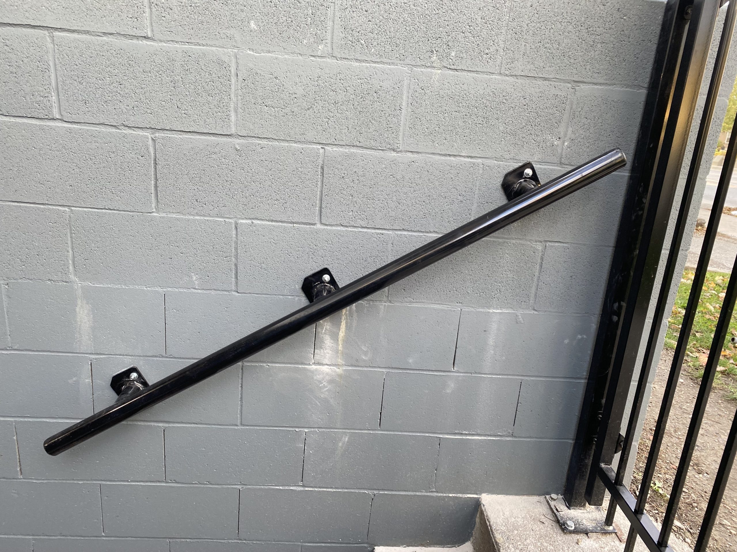 Strong tube handrail mounted on the wall on the right hand side. JW Portable Welding & Repairs 2021 London, Ontario
