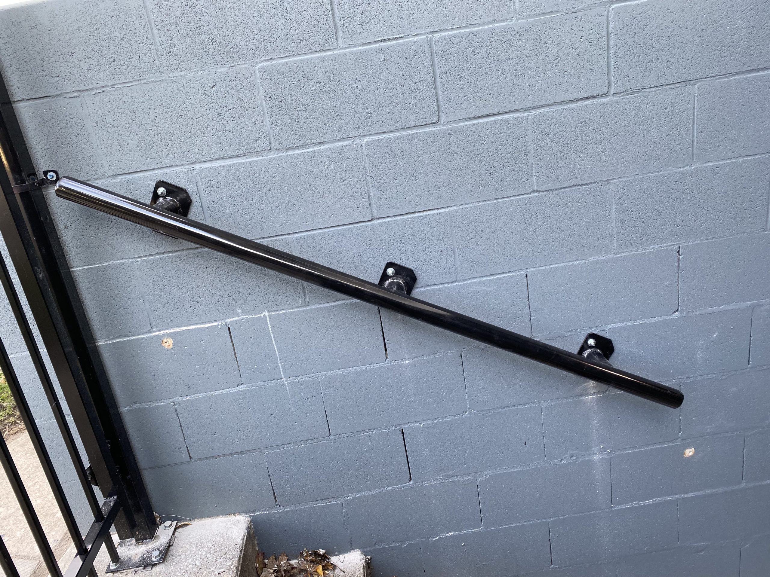 Strong tube handrail mounted on the wall on the left hand side. JW Portable Welding & Repairs 2021 London, Ontario