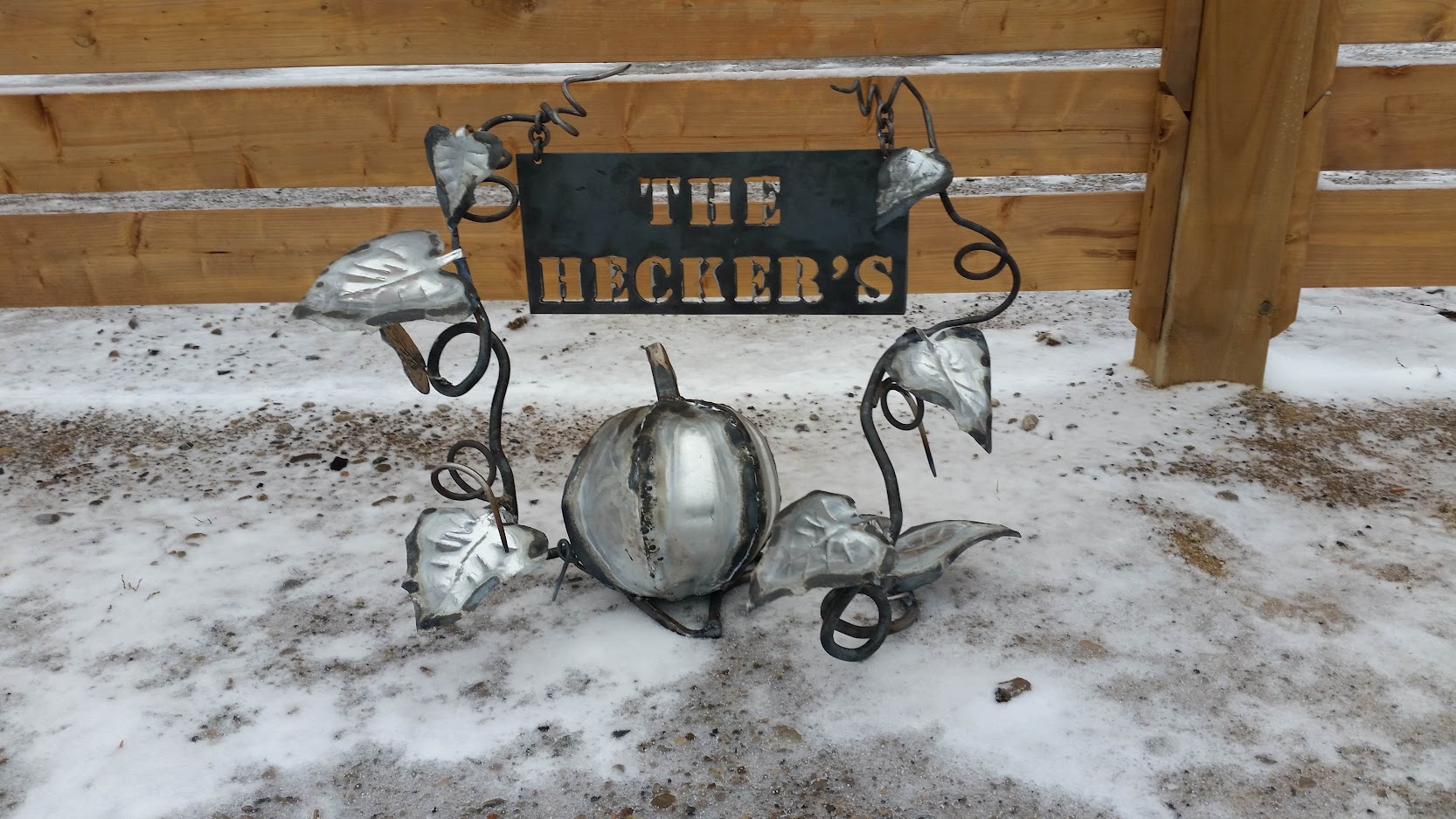 The metal pumpkin plant with multiple leaves and large pumpkin has a family name sign, stands in front of the house. JW Portable Welding & Repairs, 2020 London, Ontario