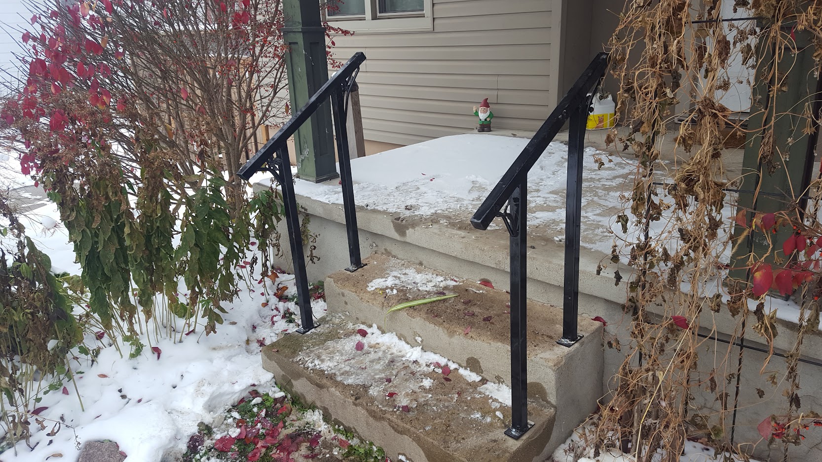 Two modern outdoor railings , painted and decorated, mounted on concrete stairs. JW Portable Welding & Repairs 2020 London, Ontario