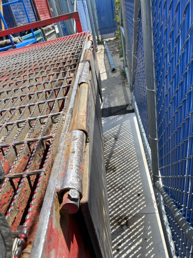 The crashed hinges do not allow workers to lift the sections of the docking ramp's lip. The lack of bumpers have caused semitrailers crashing the hinges of these floppers. Now we must replace these hinges. JW Portable Welding, London, Ontario, 2022