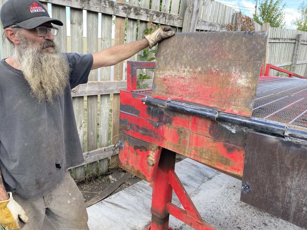 The employee is testing the flopper for easy lifting. The hinge is just tacked with a small weld at this moment. JW Portable Welding, London, Ontario, 2022