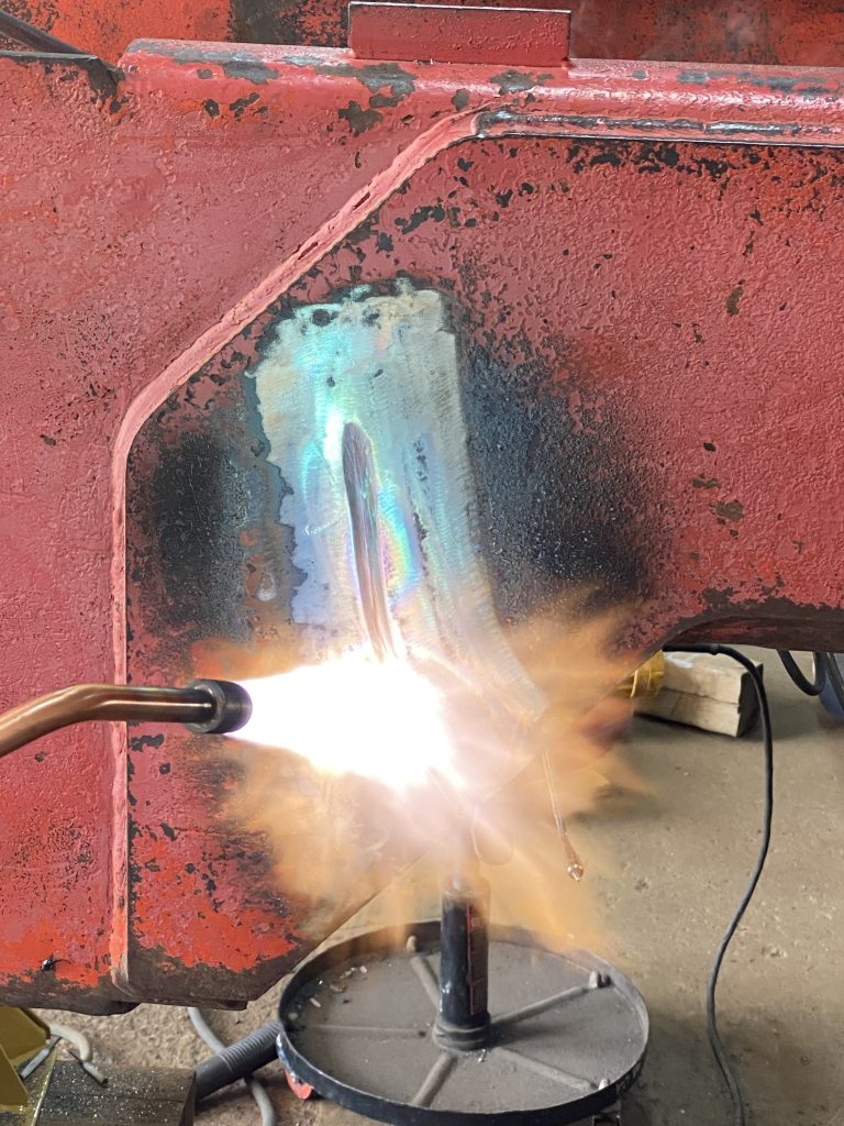 Crack 5 on the outside plate has being preheated with a rosebud torch tip. The crack is grooved and the root of the crack is clearly visible. The paint surrounding the crack is removed and the bear metal is exposed. August 12, 2025 for JW Portable Welding & Repairs, Lucan Ontario