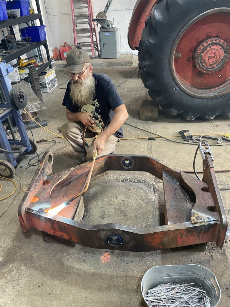 Preheating to constant temperature with rosebud torch tip the skidder's walking beam prior welding. August 15, 2025, for JW Portable Welding & Repairs, Lucan Ontario.