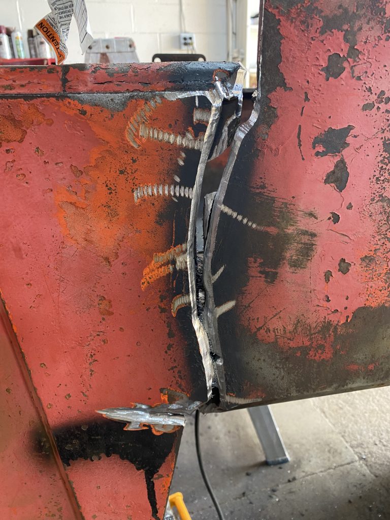 Beveled Crack 1 on Timberjack skidder. The beveling with the grinder has maintained the major curves of the crack but it has removed the smaller imperfections. The cracks exposes the double plate composition of this structural element. The crack on the other side has also been beveled in the same fashion. August 11, 2025, For JW Portable Welding & Repairs, Lucan Ontario