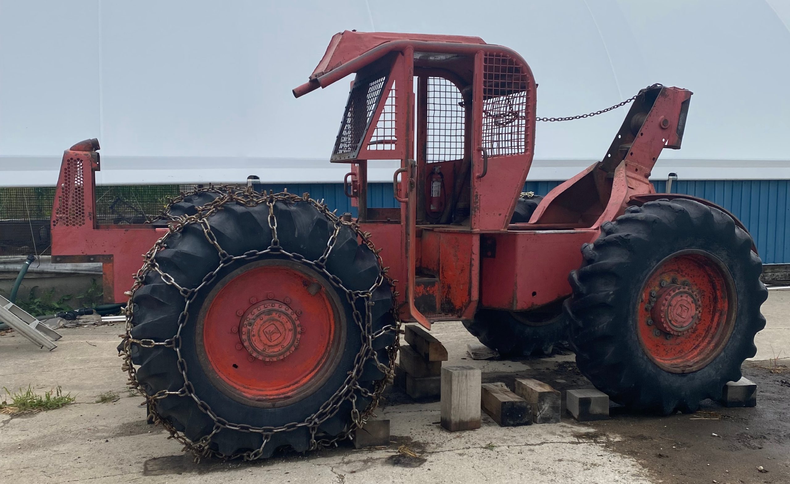 Timberjack skidder Model # HSEAX with critical damage of the front frame standing with front axle still attached. July 31, 2025 for JW Portable Welding & Repairs, Tavistock Ontario.