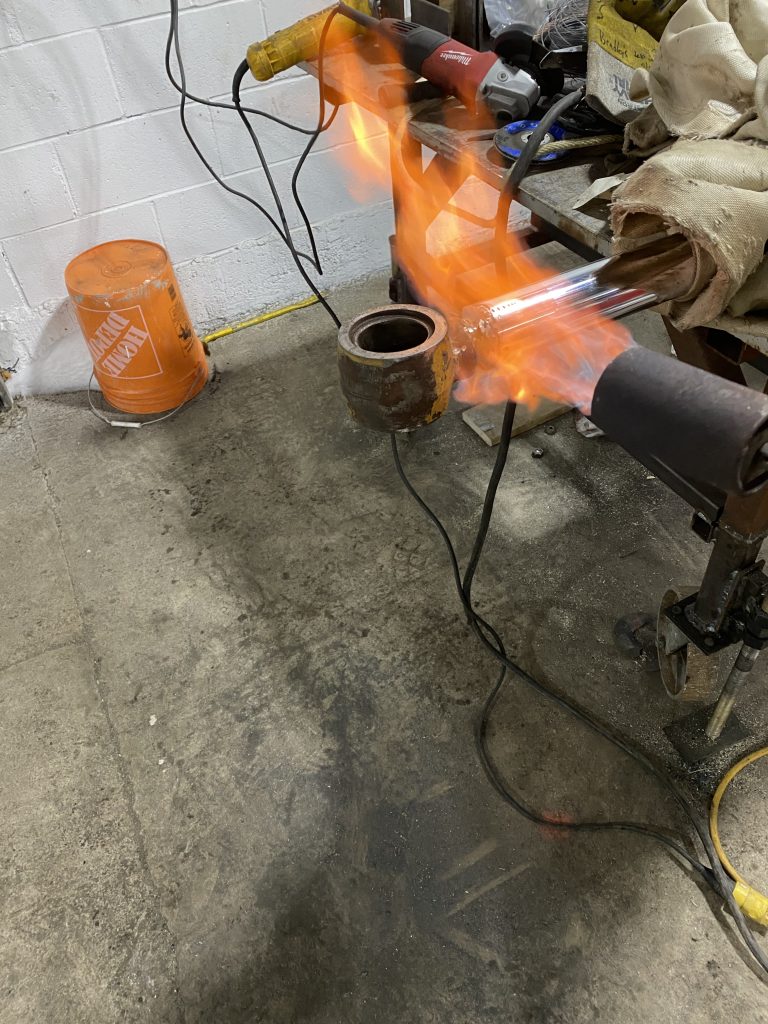 Preheating the eye of the cylinder rod with propane torch prior welding. JW Portable Welding & Repairs. Lucan Ontario, January 16, 2025