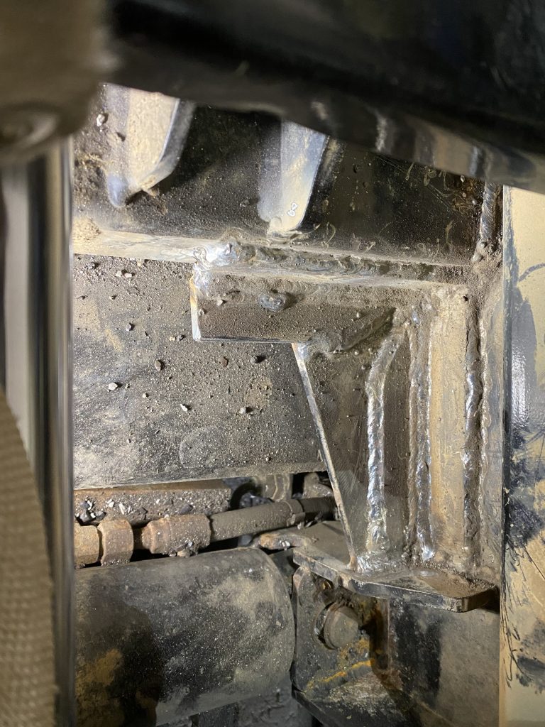 The welder has welded a split fish angle solution to stabilize the joint within this heavy equipment repair process. The the fish angle used to stabilize the frame forms a corner that is welded to the frame to disallow displacement of angle under excessive force. JW Portable Welding, London, Ontario, May 2 2023