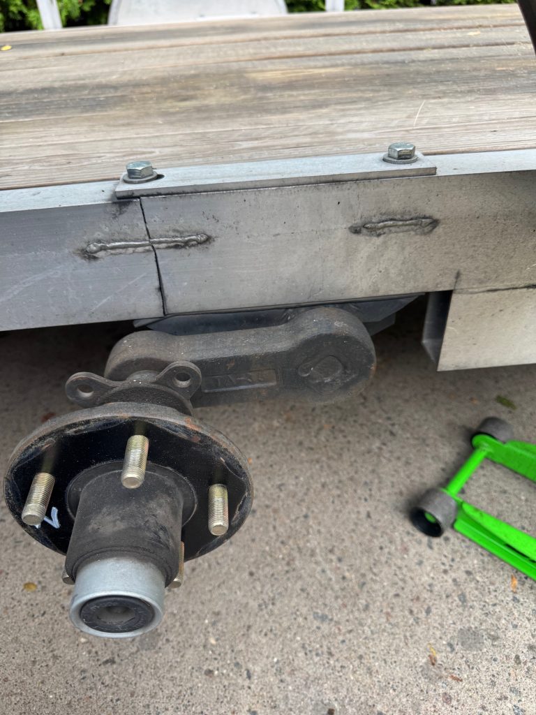 A vertical crack in aluminum single axle trailer sent by client. The crack has initiated at the bottom of the frame where the hole is for a steel bold. JW Portable Welding November 8, 2025