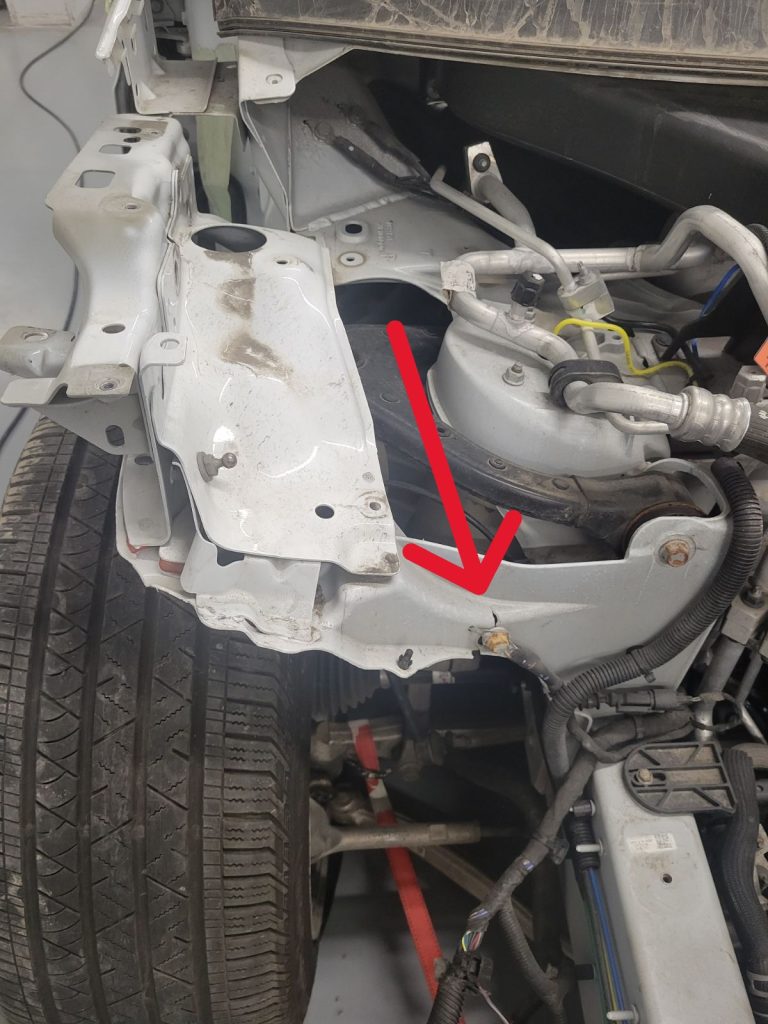 The red arrow points to the major crack in aluminum bracket of Tesla Model X after minor thunder bender. The crack is close to the steel bolt. December 6, 2023 For JW Portable Welding & Repairs Aylmer Ontario