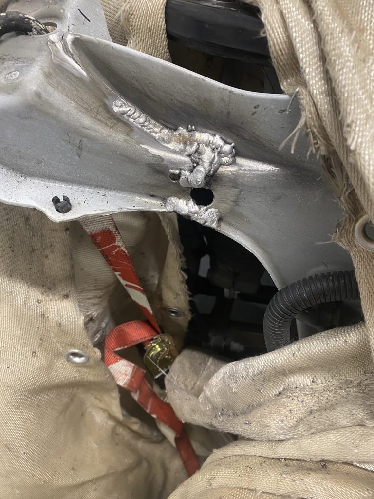 Repair weld of the main crack in the aluminum bracket of Tesla Model X 100 D by aluminum mobile welding service in temporary Tesla body shop on client's premises. The thicker weld of multiple passes increases the strength of the repair. December 6, 2023 for JW Portable Welding & Repairs, Aylmer Ontario.