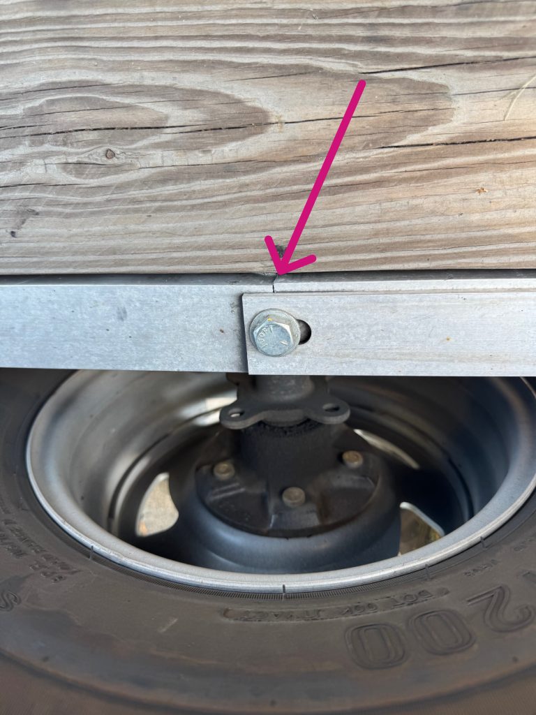 The red arrow points to location where this crack has started. The most probable cause is a multiple impact due to driving over pothole with this single axle aluminum trailer. JW Portable Welding & Repairs, November 8, 2025