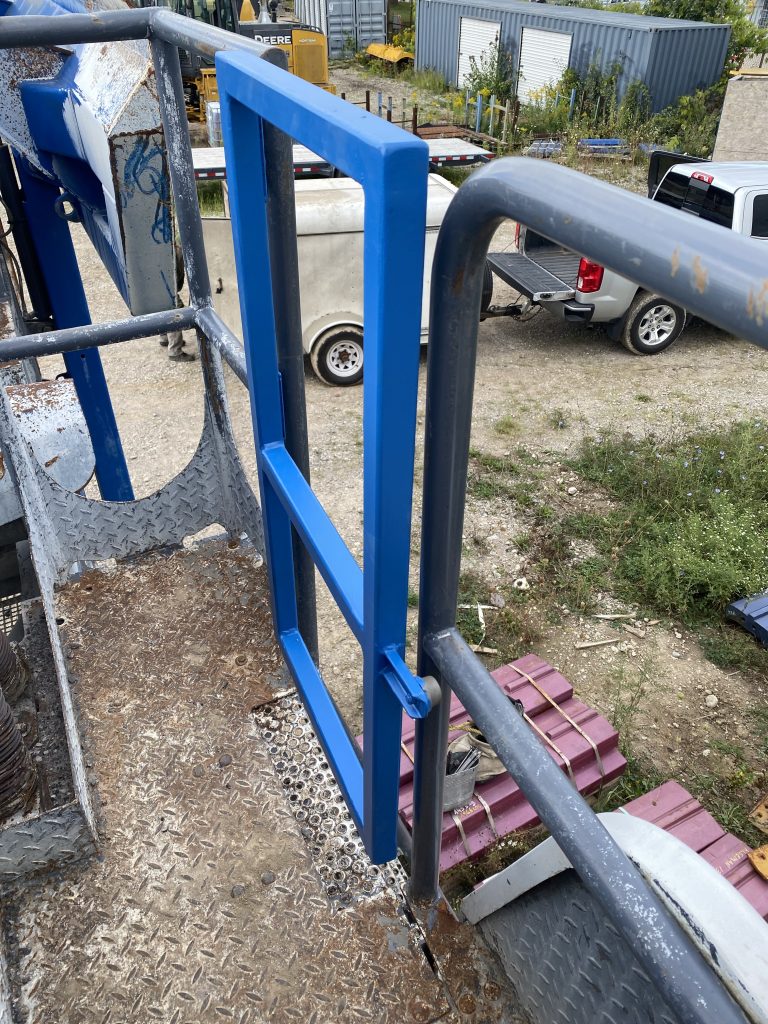 The closed gate from the bumper side. The bumper engages into the old railing and it restrains the movement of the gate to open outside.