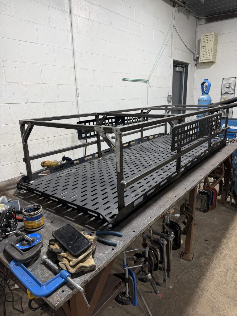 New metal fabricated rack that allows for sleeping on top of the small camp trailer. Designed and fabricated by JW Portable Welding & Repairs, Lucan. 2026
