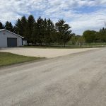 New gravel driveway for clients with heavy equipment that is 75 feet wide and has a smooth slope. For JW Portable Welding, 2026, Lucan