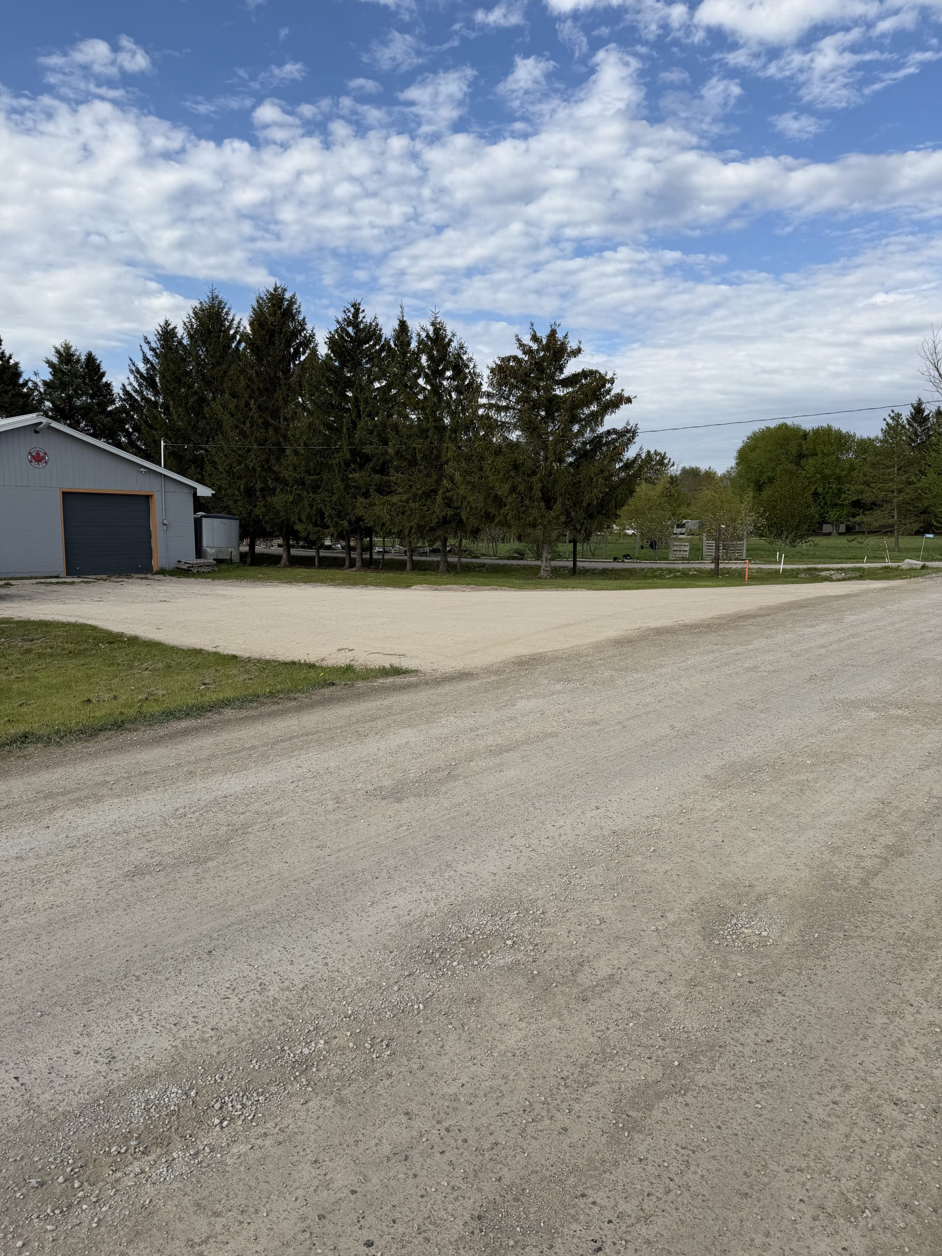 New gravel driveway for clients with heavy equipment that is 75 feet wide and has a smooth slope. For JW Portable Welding, 2026, Lucan