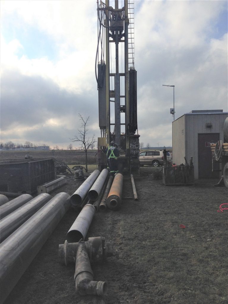 Water drillers rig with 18 inch stainless steel sleeves lying on the ground. For JW Portable Welding & Repairs, 2020, Dutton