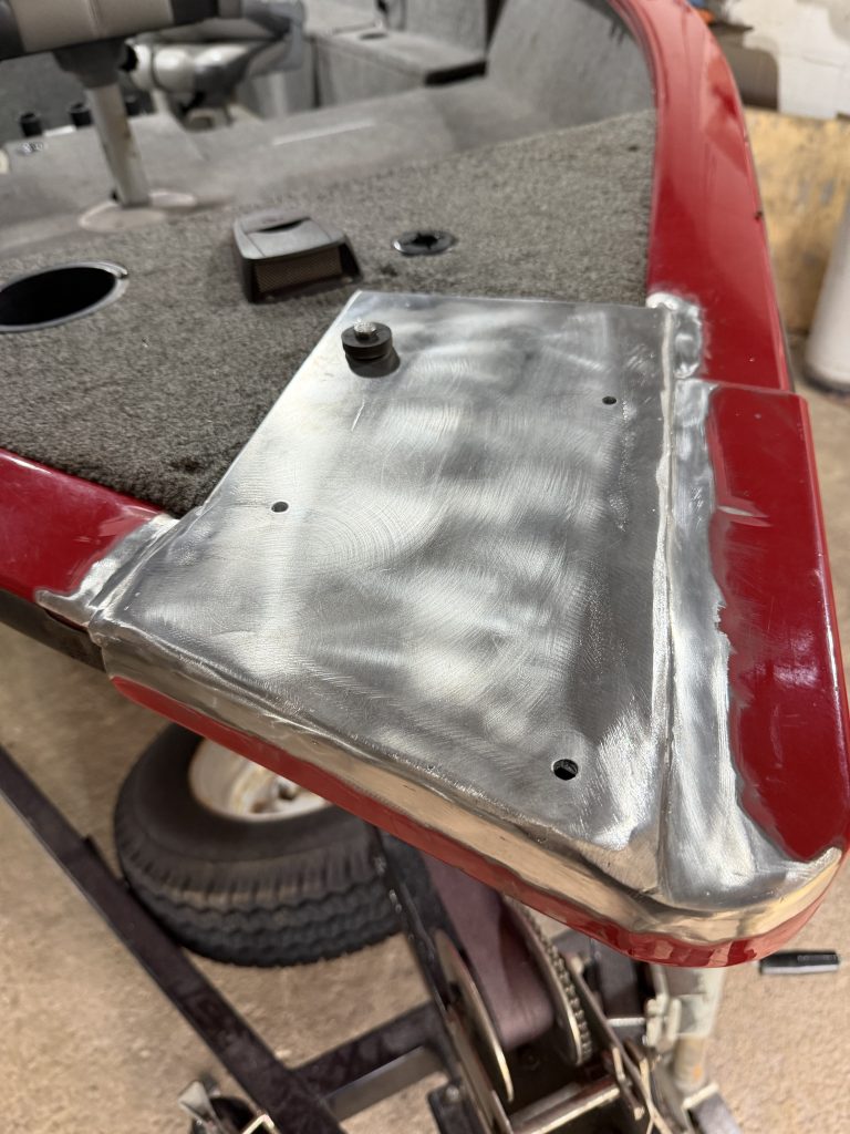 The modified plate of the trailing motor mount has been welded to the aluminum boat's bow. Surfaces are grinded, polished and buffed according to client's request. The plate features all 4 mounting holes in one plane that eliminates source of vibration. Previously one mounting hole was placed on wooden structure covered by fuzzy fabric that was positioned at much lower elevation. In this aluminum boat repair by welding we have not only eliminated the source of vibration but also increased the resistance of mounting plate to the fatigue vibration by welding much thicker mounting plate. For JW Portable Welding & Repairs, Lucan, 2026
